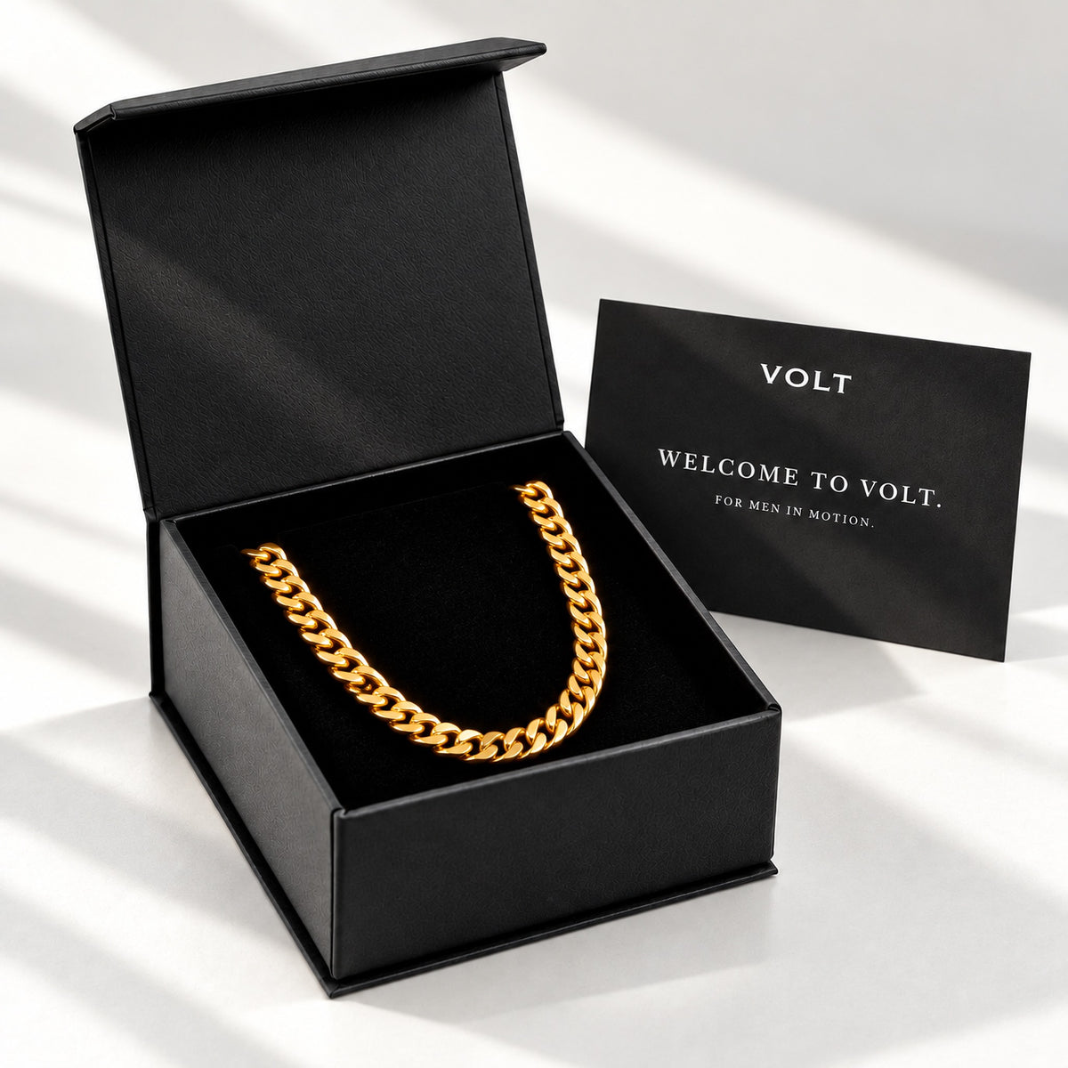 VOLT jewellery box with a gold Cuban chain and welcome care card